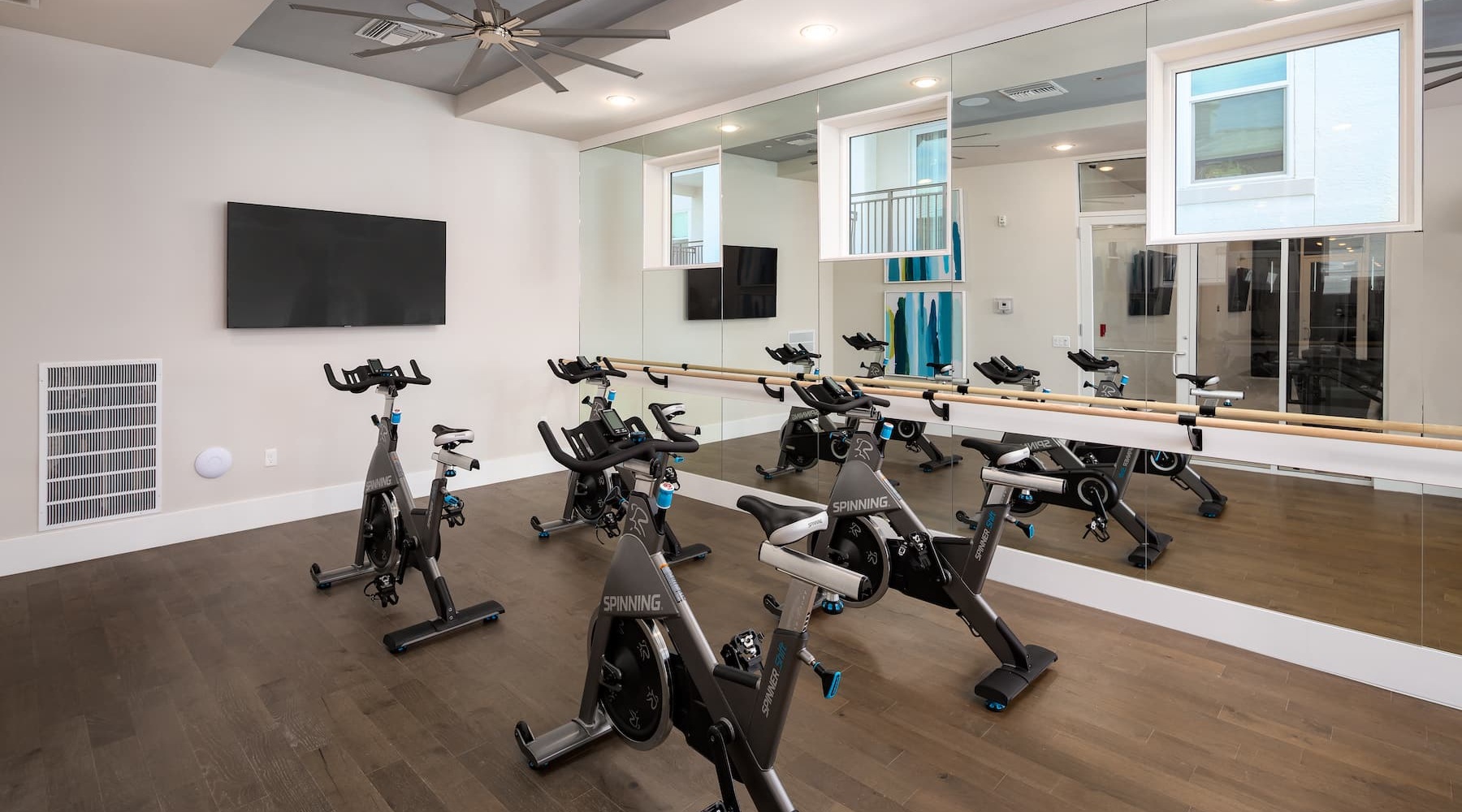 Perfect. No Matter How You Slice It. fitness room with equipment and on wood-style flooring