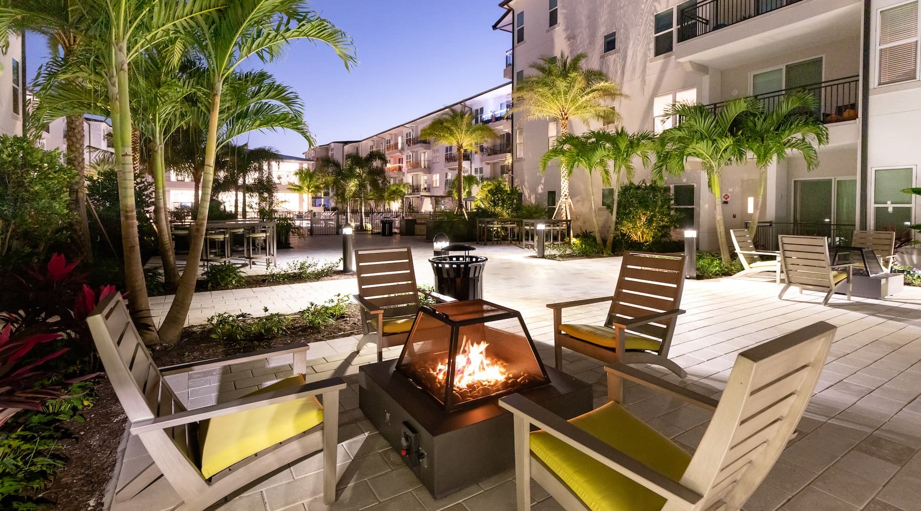 Perfect. No Matter How You Slice It. outdoor seating around a firepit and with tropical landscaping
