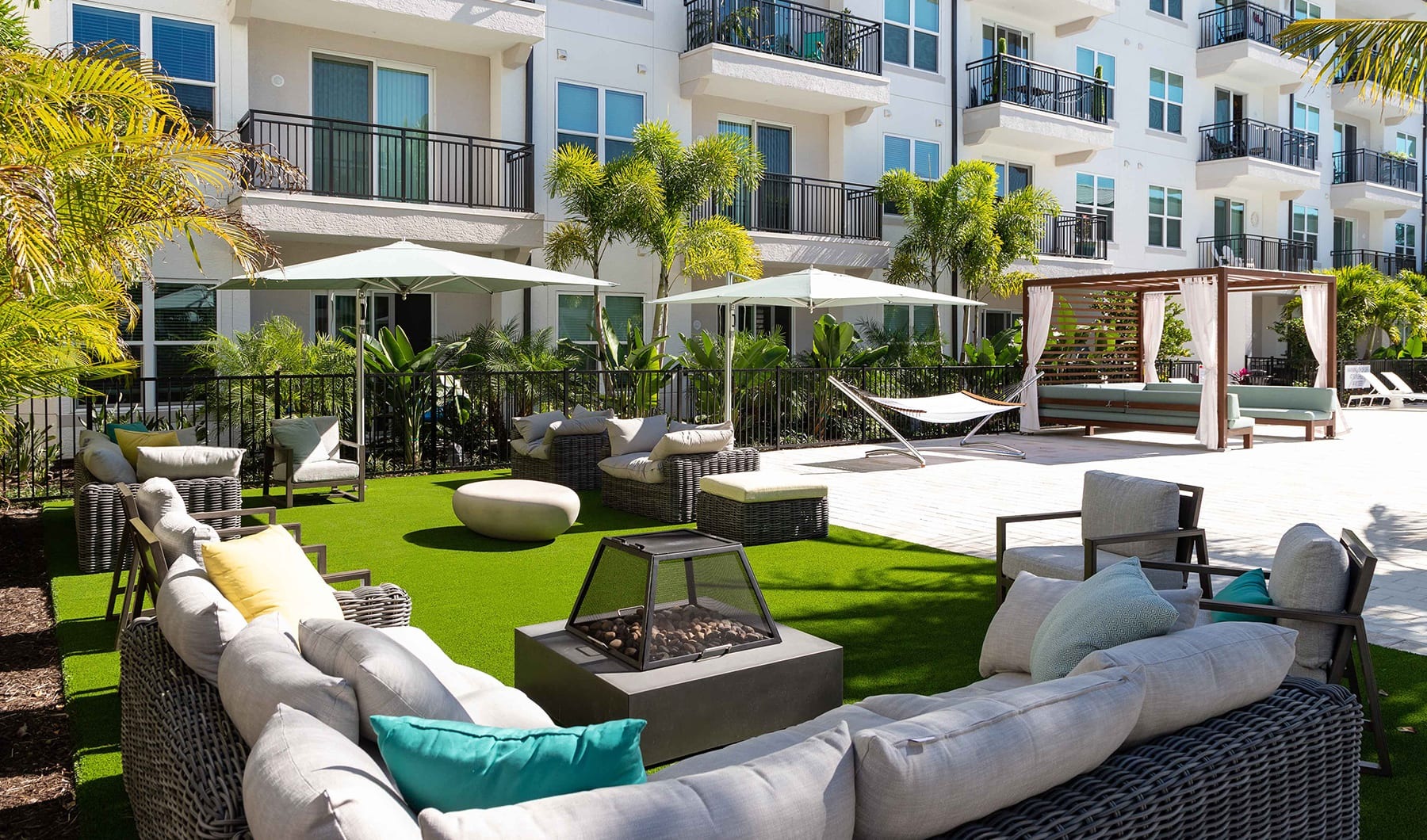 Your Perfect Slice of Lifestyle courtyard with green turf and modern seating