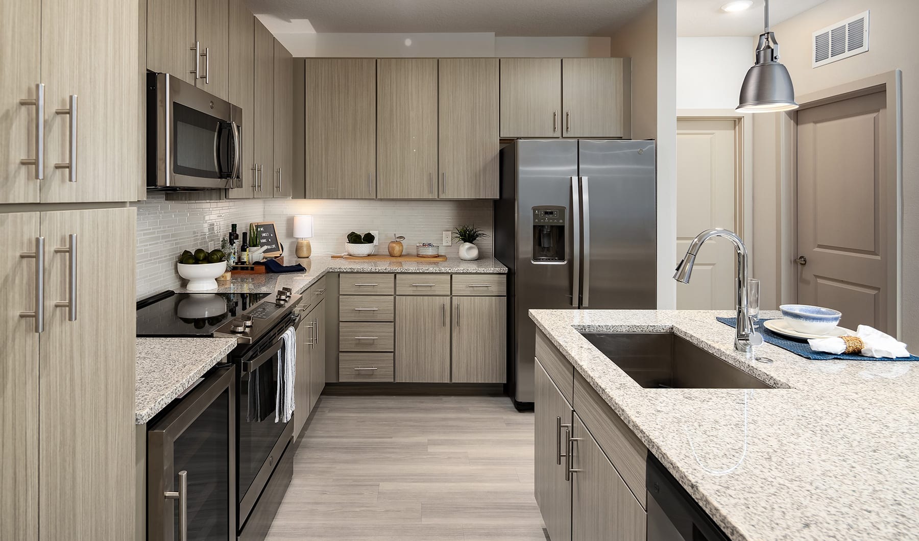 Freshly Squeezed Luxury Apartments kitchen with a near dining area and with modern appliances